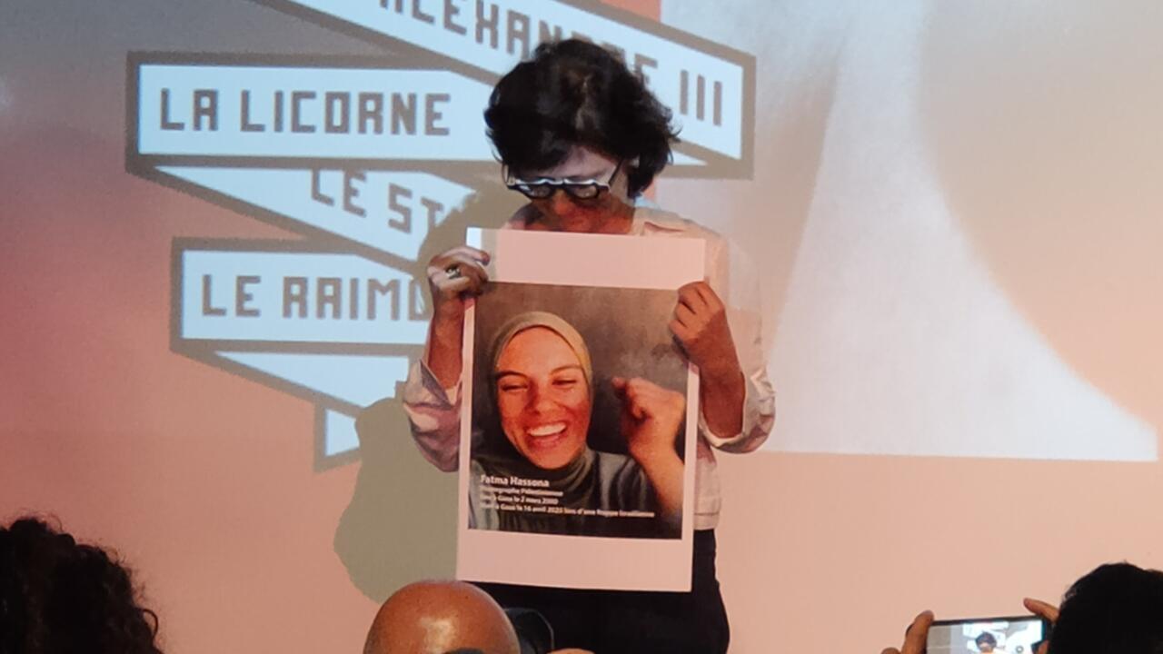 Filmmaker Sepideh Farsi holds a picture of Gaza photojournalist Fatma Hassona in Cannes on May 15, 2025. © David Rich, FRANCE 24